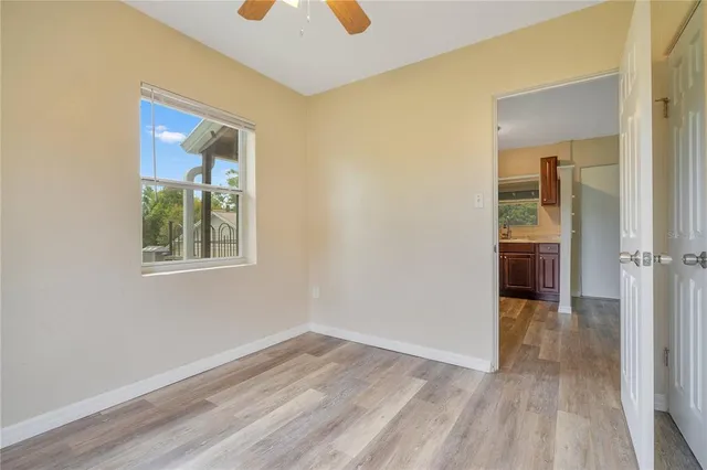 an empty room with wooden floor and a window