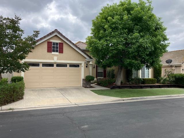 2157 West Rue St Michel Fresno, CA 93711 - Photo 1 of 22 a view of backyard of house garage and trees