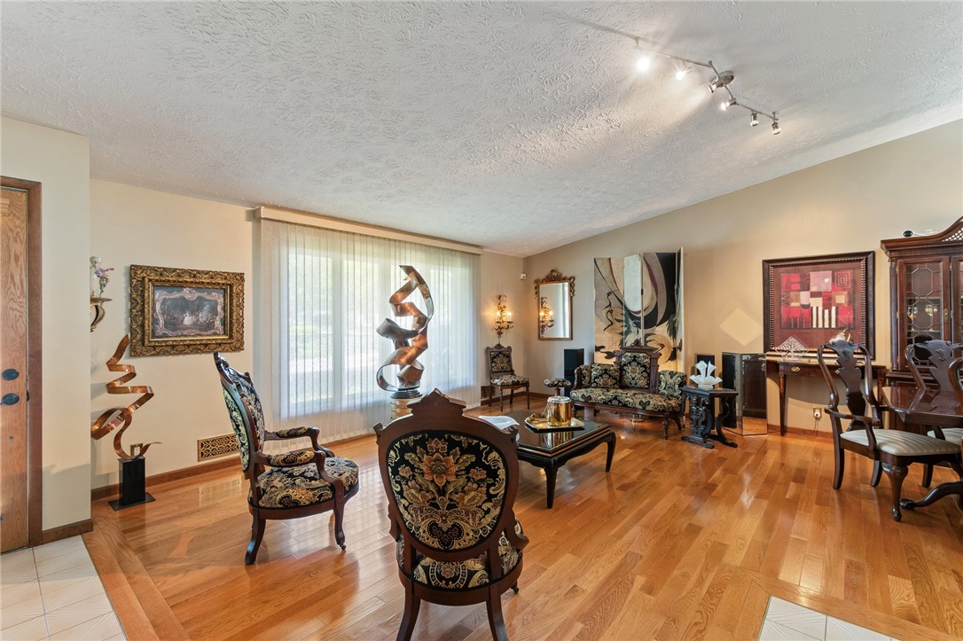 85 Stover Road Chili, NY 14624 - Photo 10 of 41 walk in the front door and be IMPRESSED by the GLEAMING HARDWOODS and VAULTED CEILINGS! Huge windows give you a FLOOD OF NATURAL LIGHT!