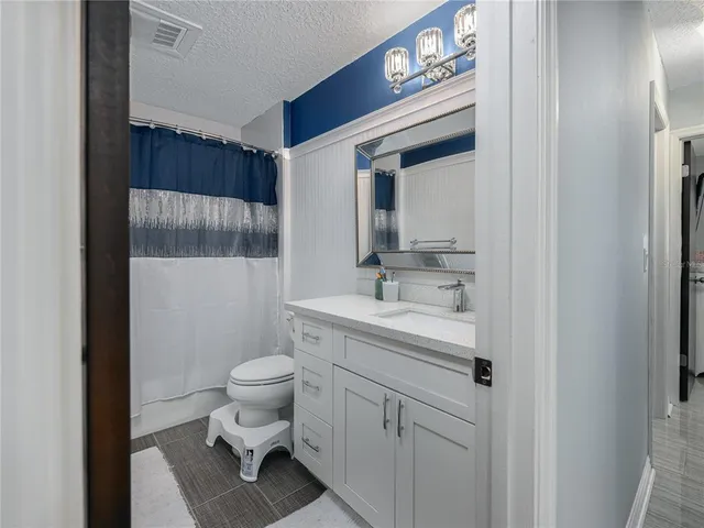 a bathroom with a sink toilet and a mirror