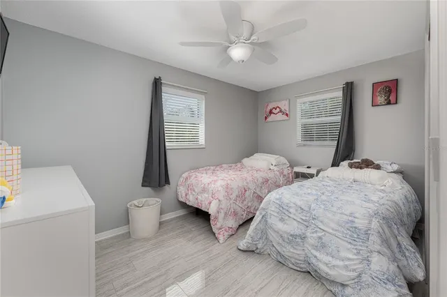 a bedroom with two beds and a table