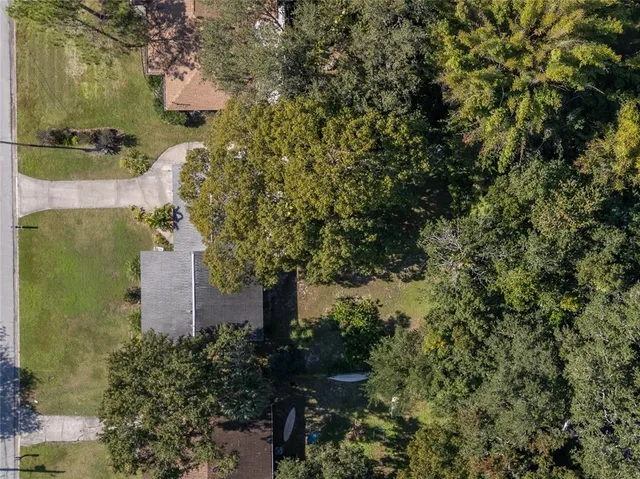 an aerial view of a house with a yard