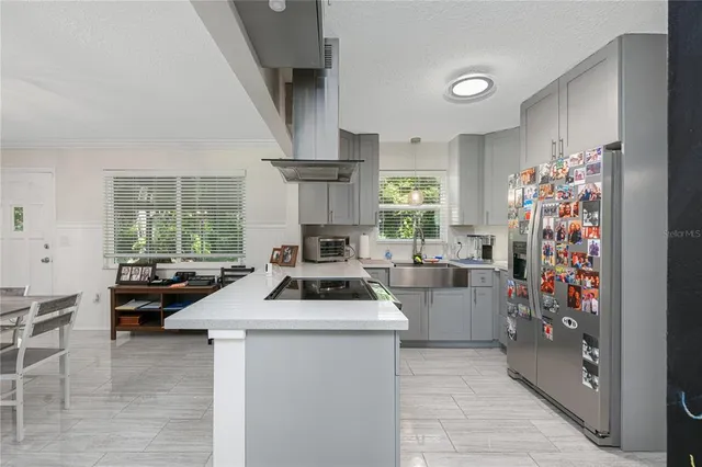 a kitchen filled with a white stove top oven and cabinets