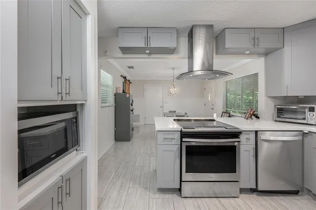 a kitchen with stainless steel appliances granite countertop a stove and a refrigerator