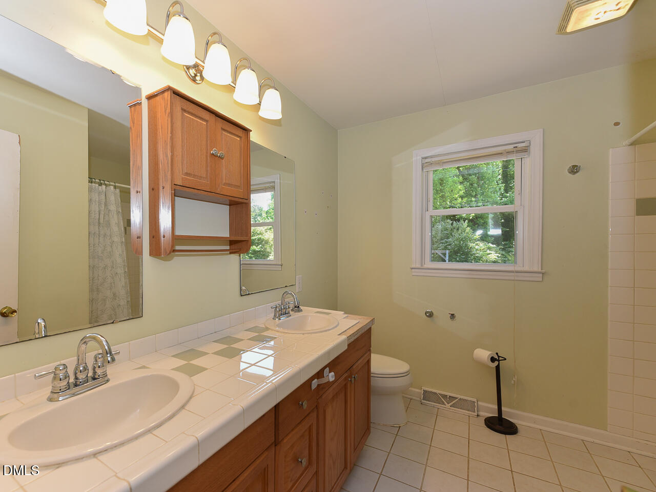 1703 St Patrick Drive Raleigh, NC 27603 - Photo 17 of 29 a bathroom with a granite countertop sink a toilet and a mirror