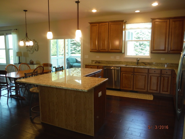 444 Reston Lane Gilberts, IL 60136 - Photo 6 of 25 a kitchen with sink dining table and chairs