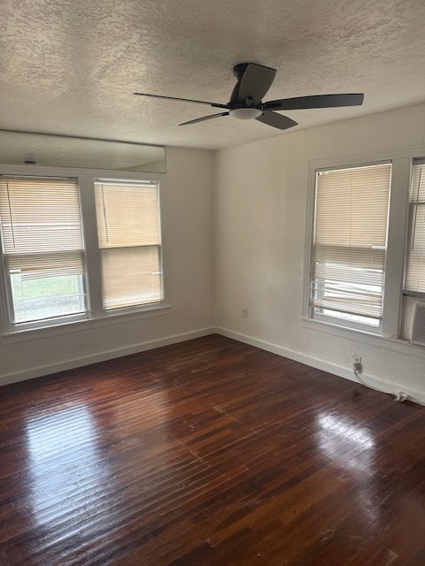4517 Hirsch Road Houston, TX 77026 - Photo 5 of 11 a view of an empty room with wooden floor and a window