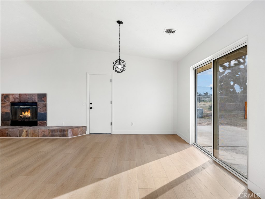 12780 Hacienda Road Phelan, CA 92371 - Photo 11 of 38 a view of a room with window and a fireplace
