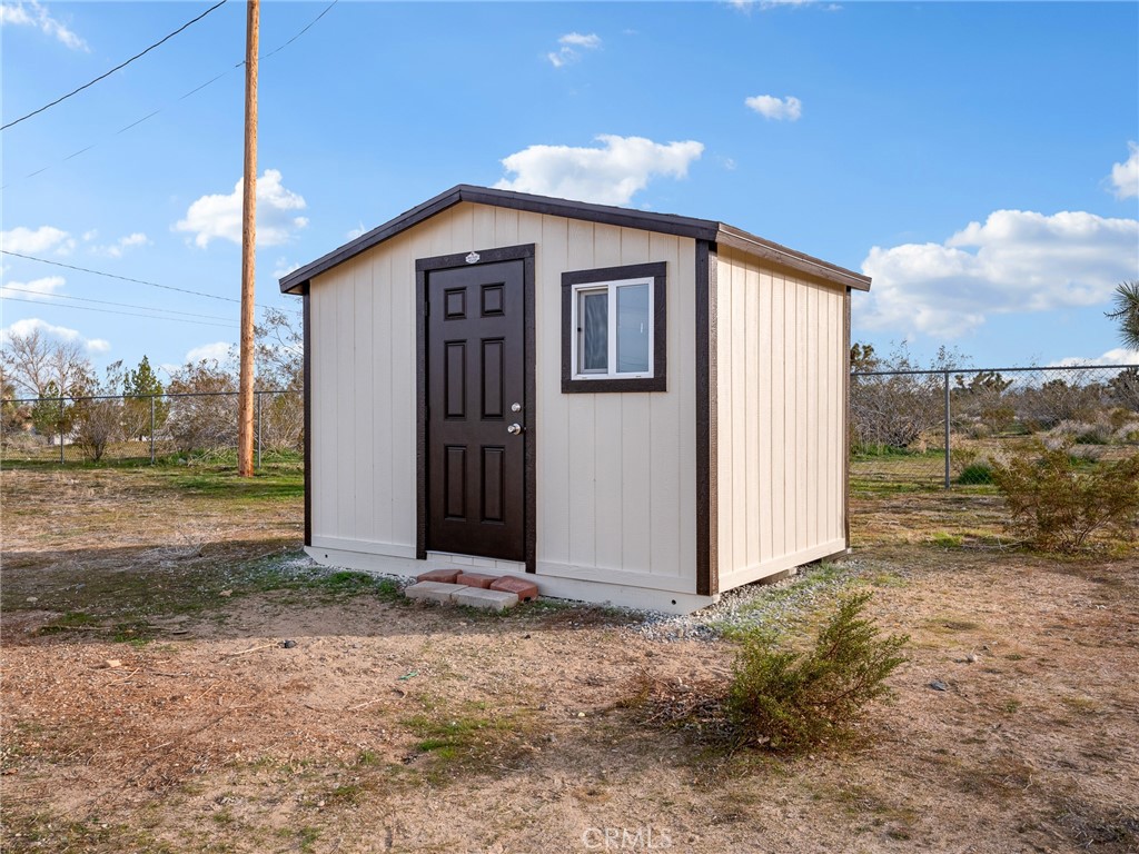12780 Hacienda Road Phelan, CA 92371 - Photo 30 of 38 a front view of a house with a yard