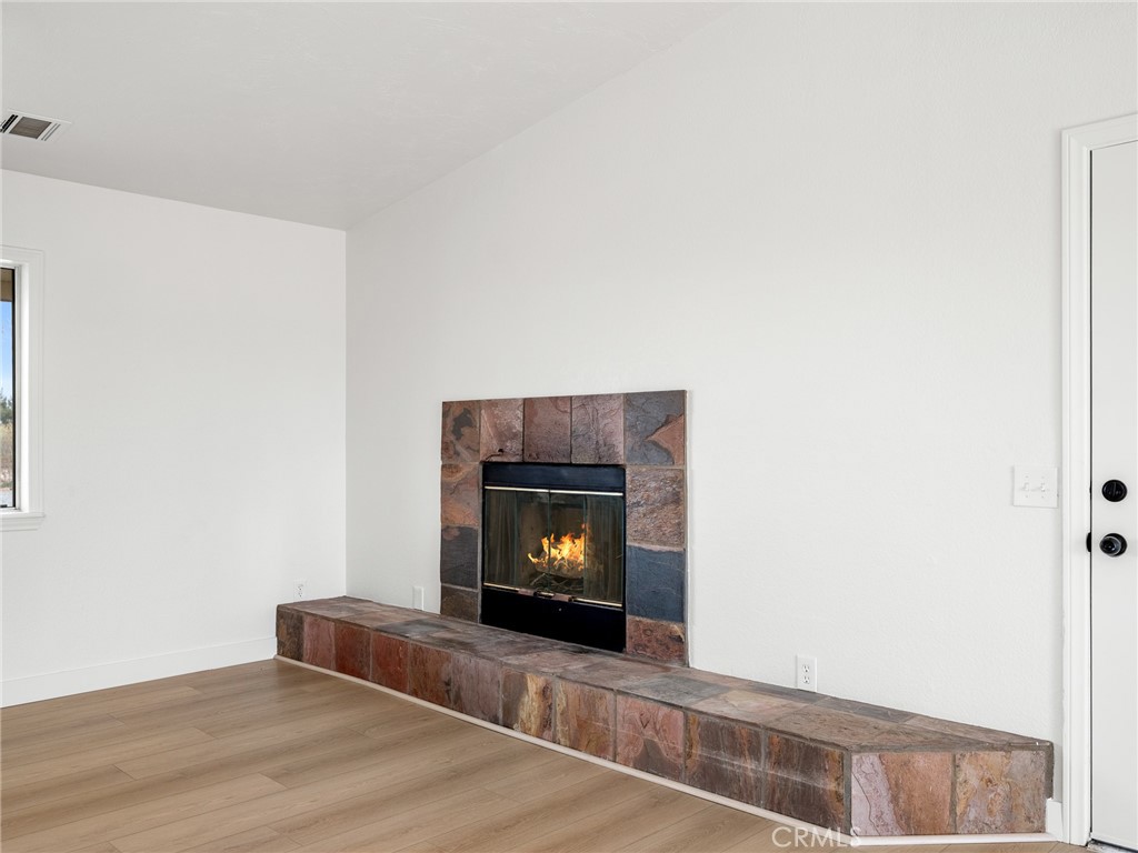 12780 Hacienda Road Phelan, CA 92371 - Photo 8 of 38 a living room with furniture and a fireplace