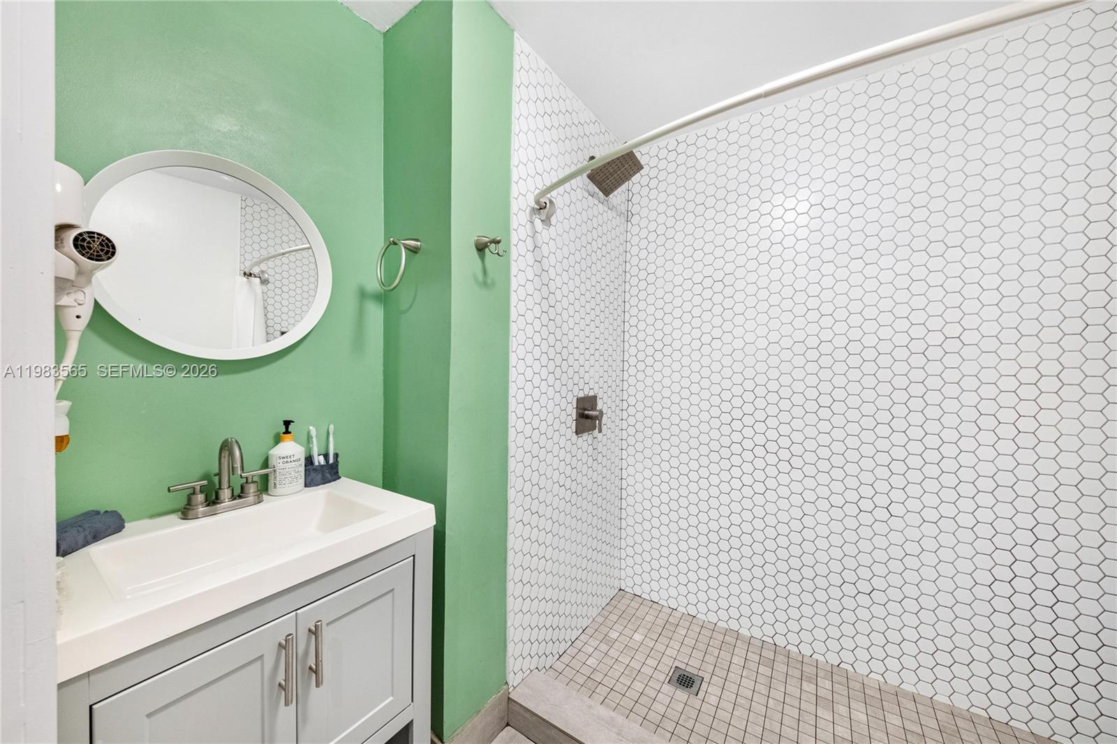 237 38th Street, Unit 4 Miami Beach, FL 33140 - Photo 14 of 28 a bathroom with a sink and a mirror