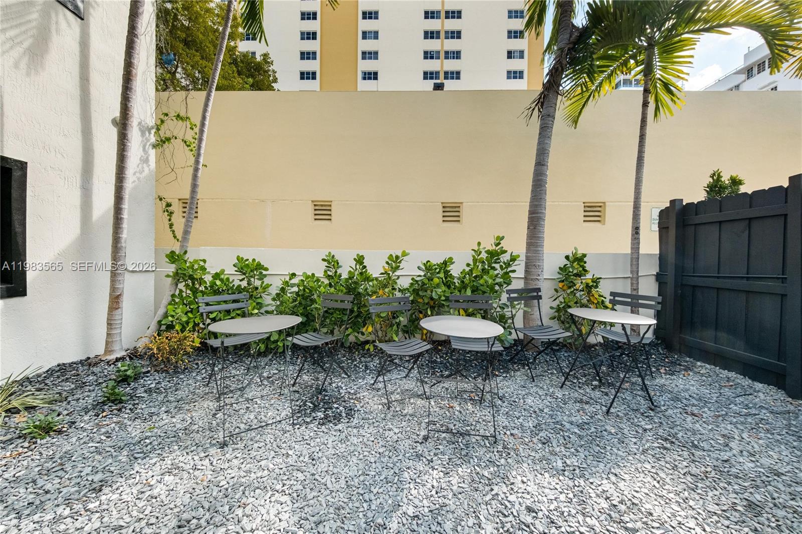 237 38th Street, Unit 4 Miami Beach, FL 33140 - Photo 23 of 28 a backyard of a house with outdoor seating