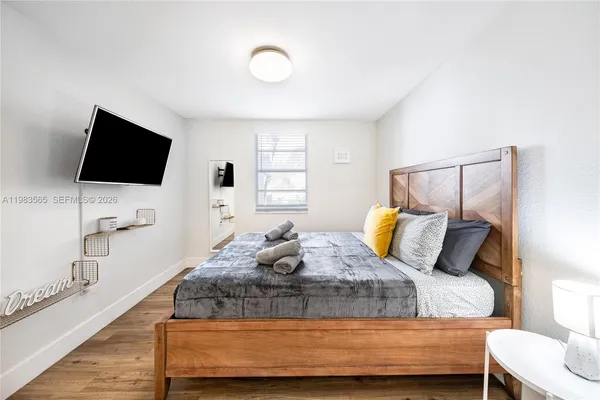 a bedroom with a bed and a flat screen tv