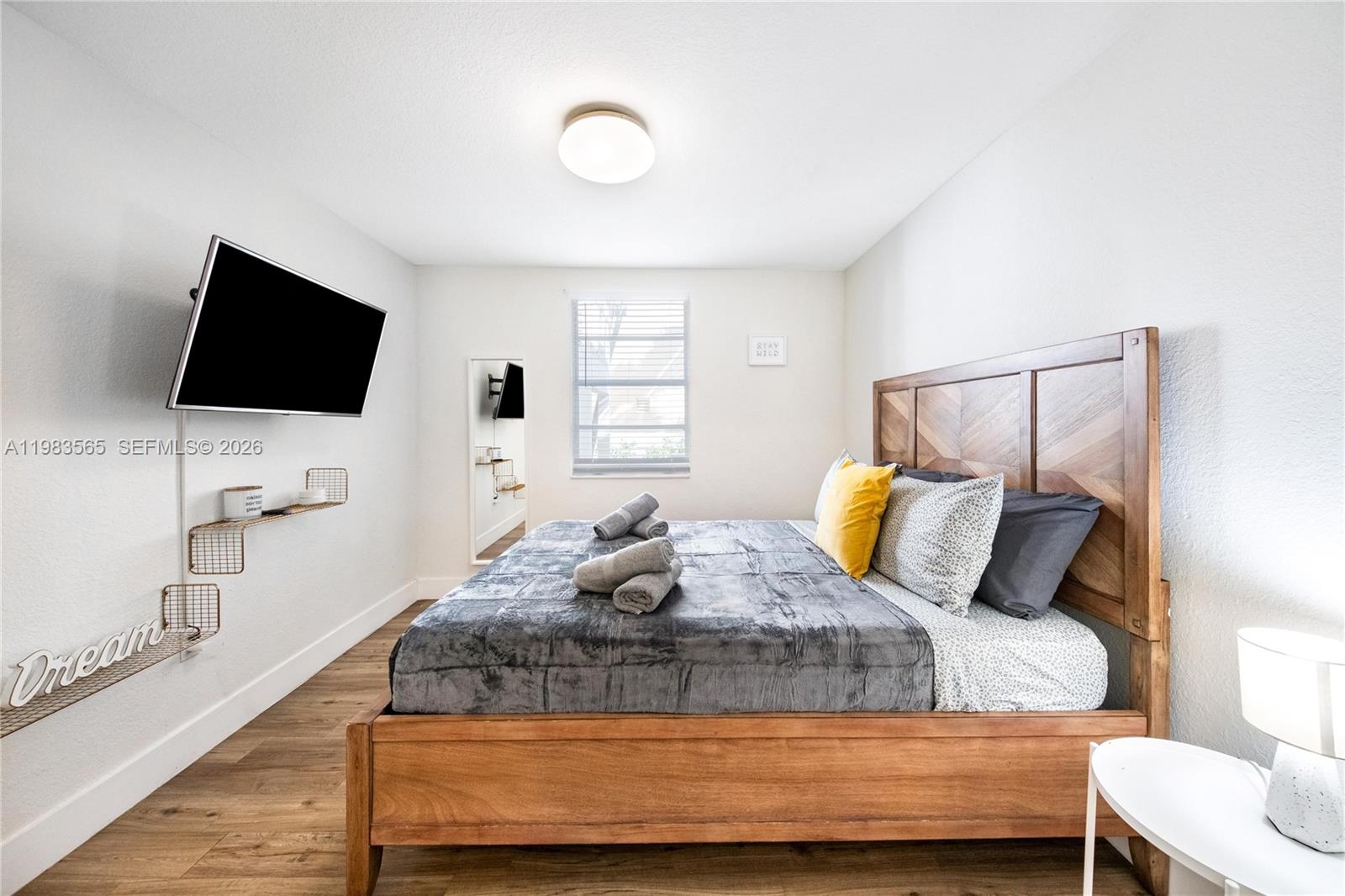 237 38th Street, Unit 4 Miami Beach, FL 33140 - Photo 4 of 28 a bedroom with a bed and a flat screen tv