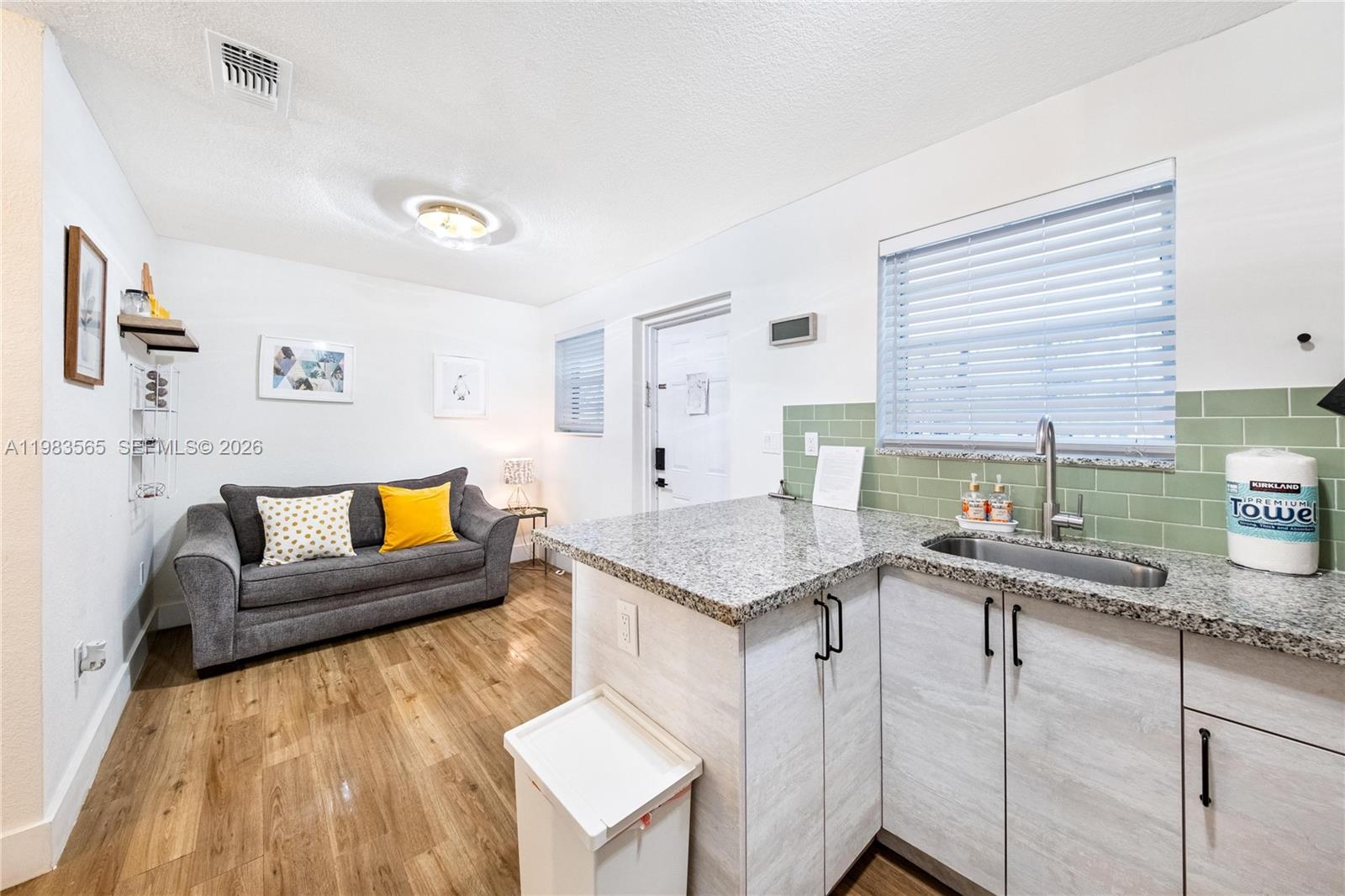 237 38th Street, Unit 4 Miami Beach, FL 33140 - Photo 7 of 28 a living room with furniture and a table