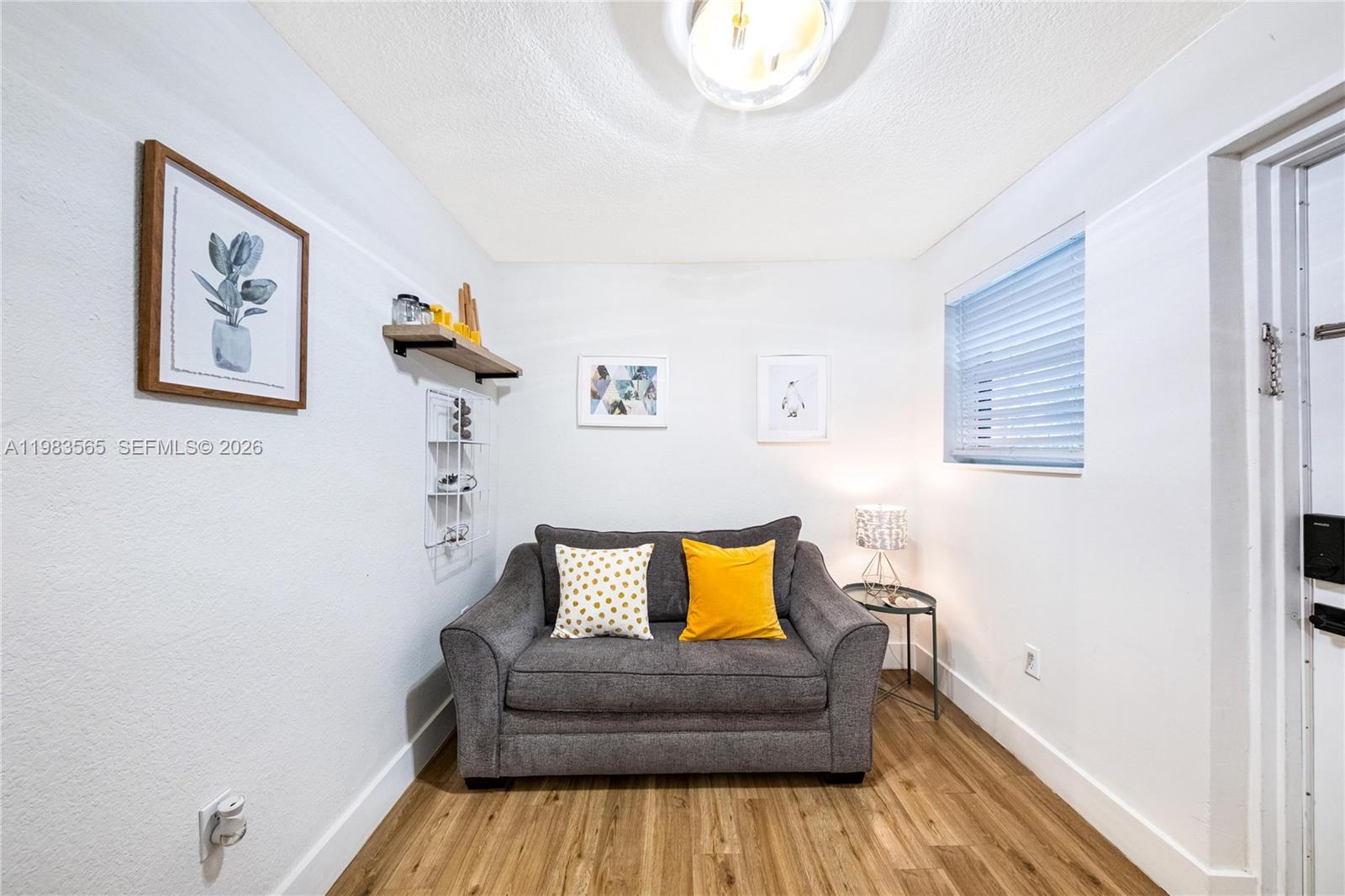 237 38th Street, Unit 4 Miami Beach, FL 33140 - Photo 9 of 28 a living room with furniture and a couch