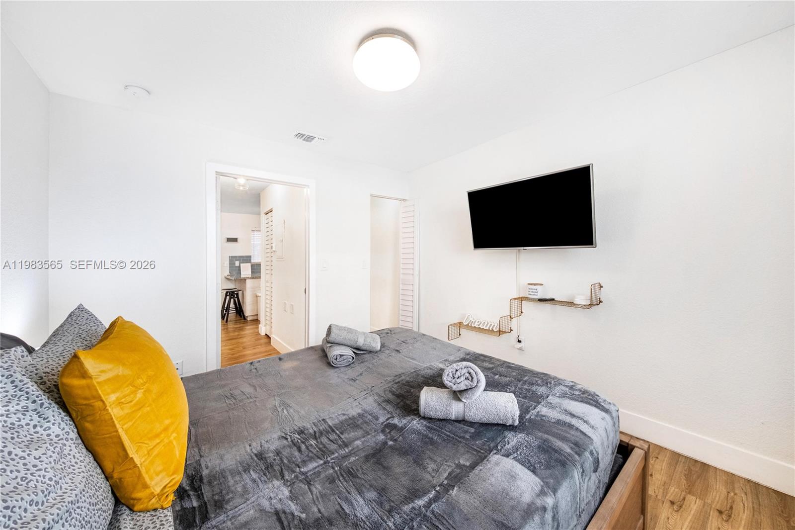 237 38th Street, Unit 4 Miami Beach, FL 33140 - Photo 10 of 28 a bedroom with a bed and a flat screen tv