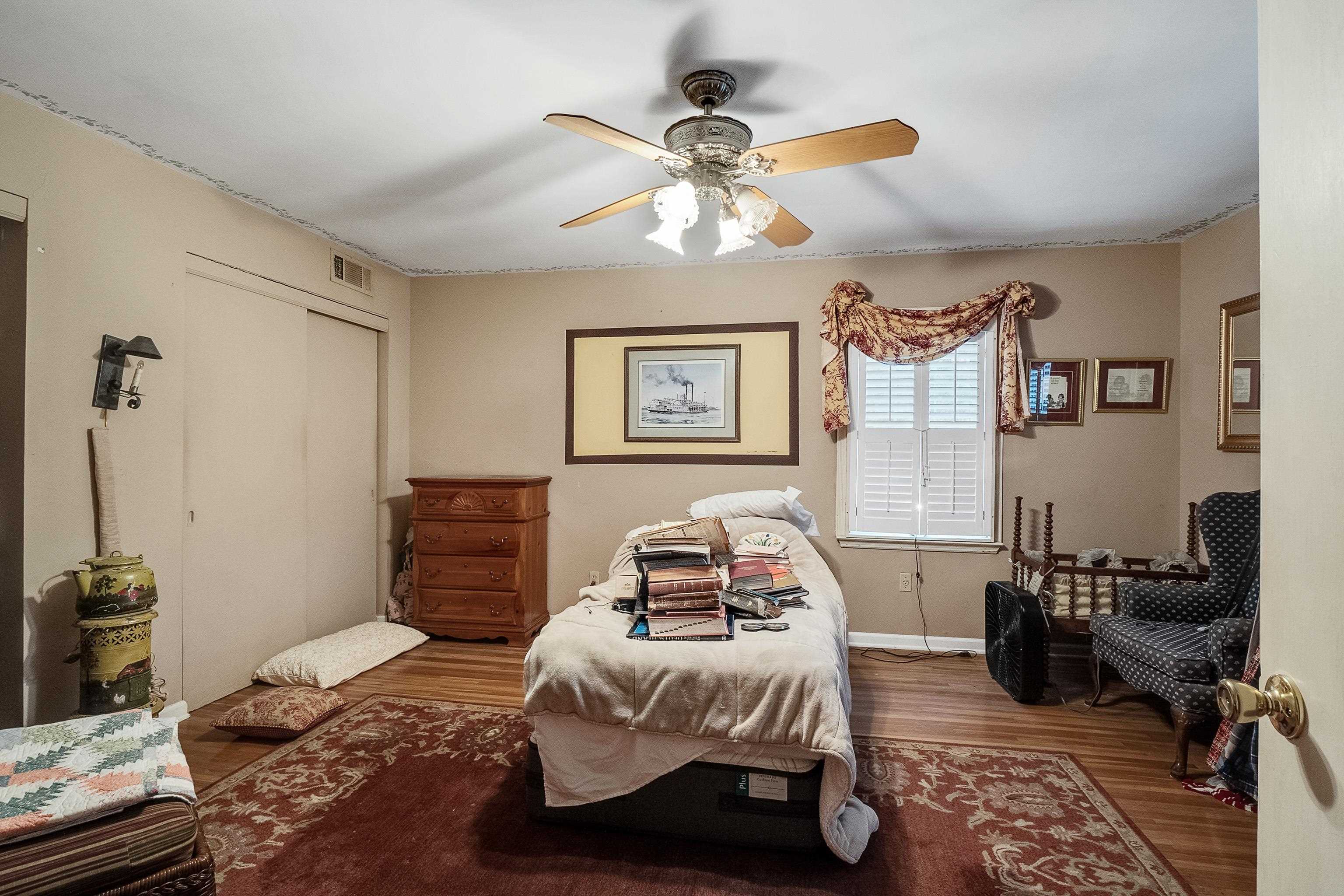5302 Dee Road Memphis, TN 38117 - Photo 14 of 18 a bedroom with a bed and wooden floor