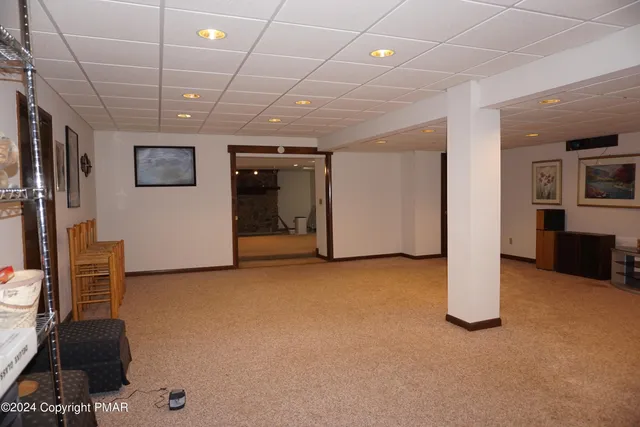 a living room with furniture a fireplace and a large window