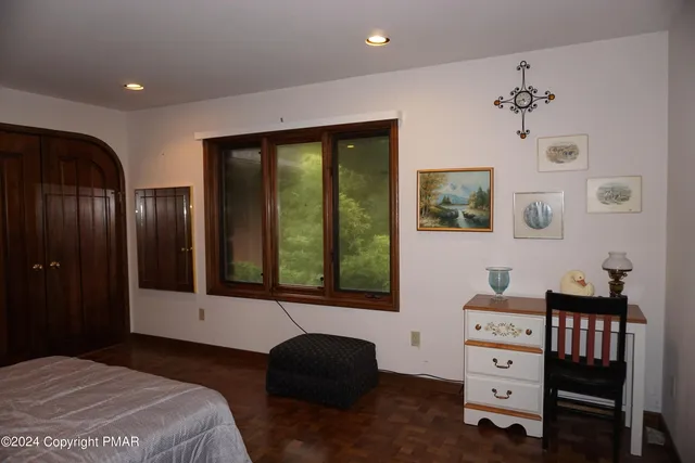 a bedroom with a bed and a large window