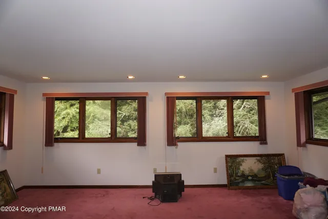 a living room with couches and a flat screen tv
