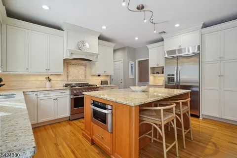 a kitchen with stainless steel appliances granite countertop a stove and a sink