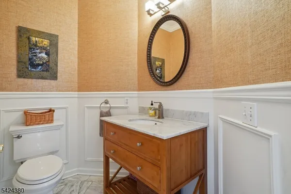 a bathroom with a toilet a sink and a mirror