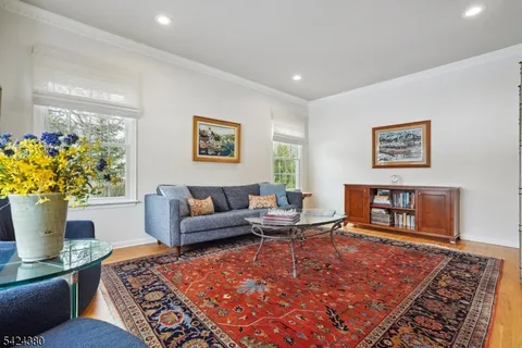 a living room with furniture a rug and a large window