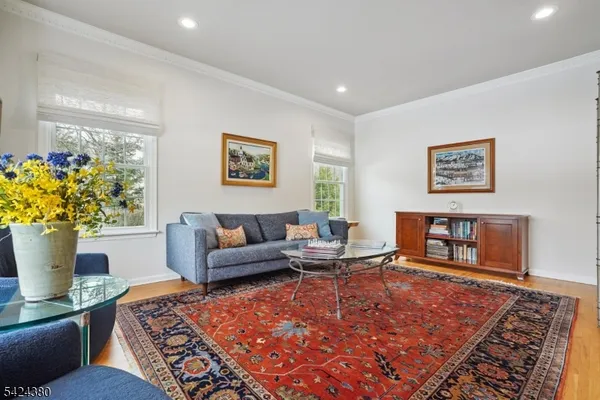 a living room with furniture a rug and a large window