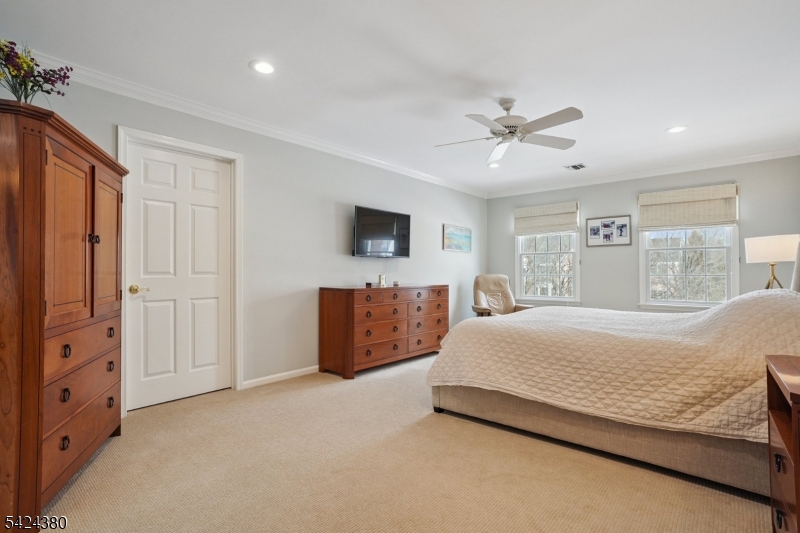 13 O'Brien Court Bedminster, NJ 07921 - Photo 29 of 50 a spacious bedroom with a large bed and a chandelier