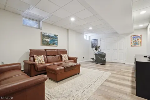 a living room with furniture a air conditioner vent and a window