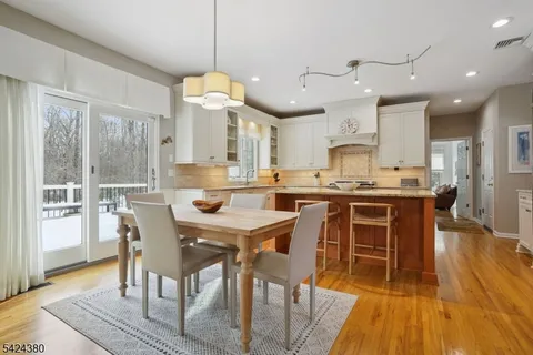 a large kitchen with a table and chairs