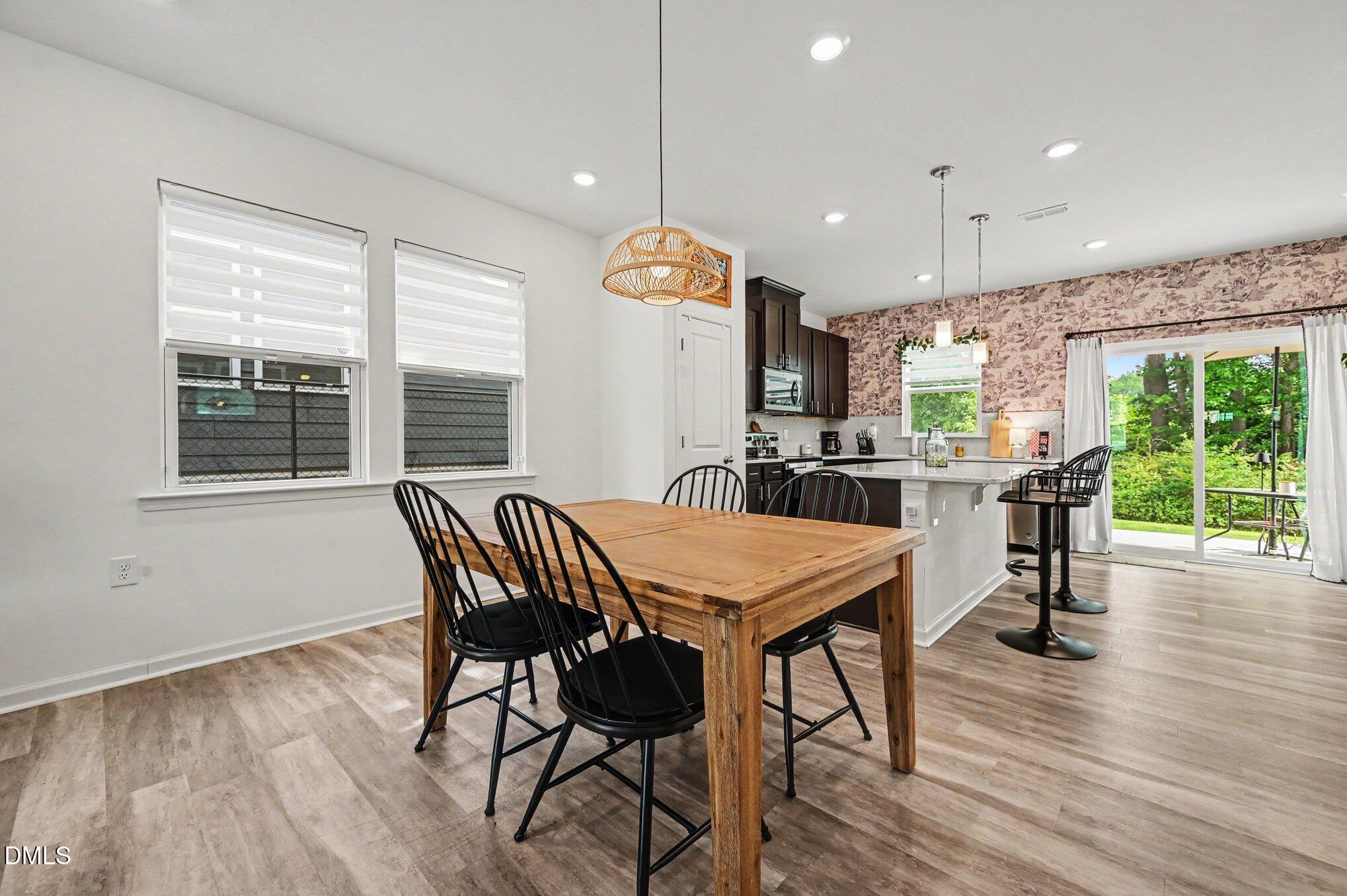 574 Hacksaw Trail Raleigh, NC 27610 - Photo 5 of 28 a view of a dining room with furniture window and wooden floor