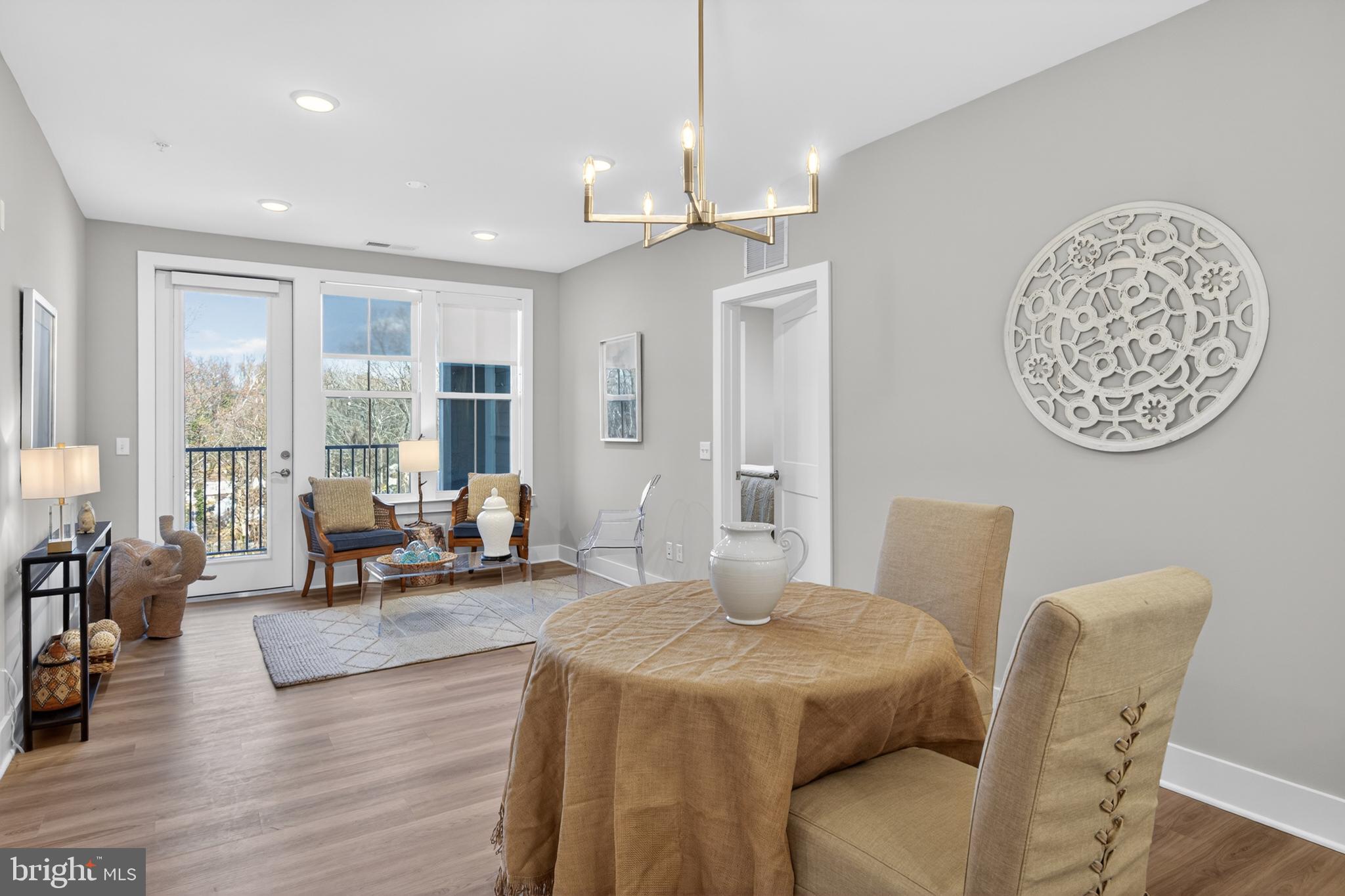 76 Old Mill Bottom Road North, Unit 203 Annapolis, MD 21409 - Photo 50 of 50 a living room with furniture a large window and a chandelier