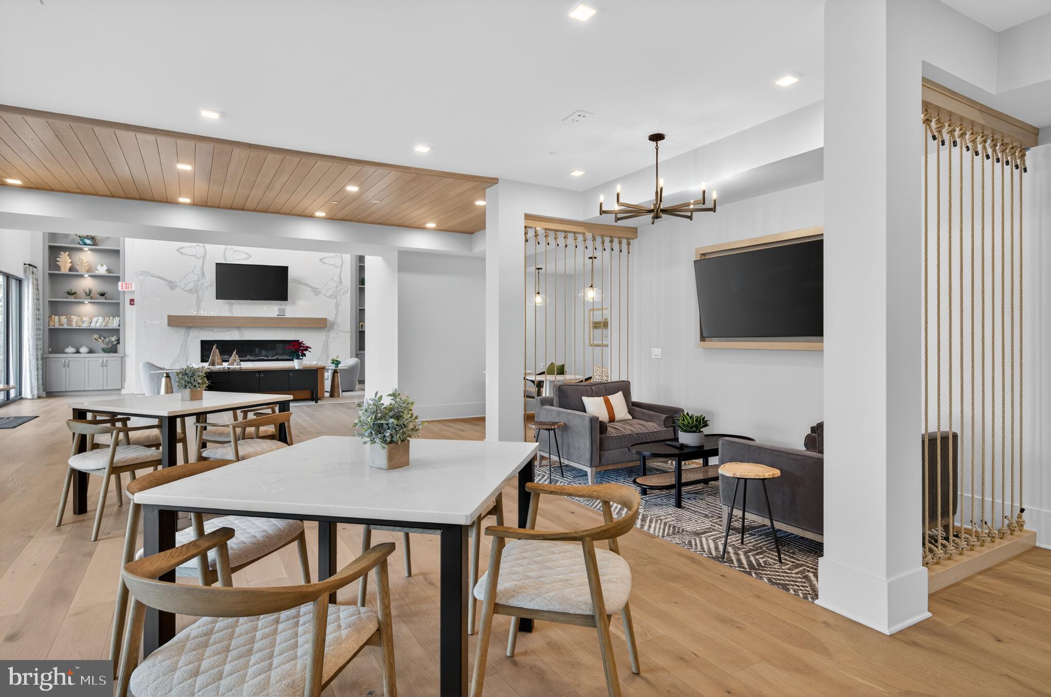 76 Old Mill Bottom Road North, Unit 203 Annapolis, MD 21409 - Photo 29 of 50 a view of a dining room with furniture wooden floor and a flat screen tv