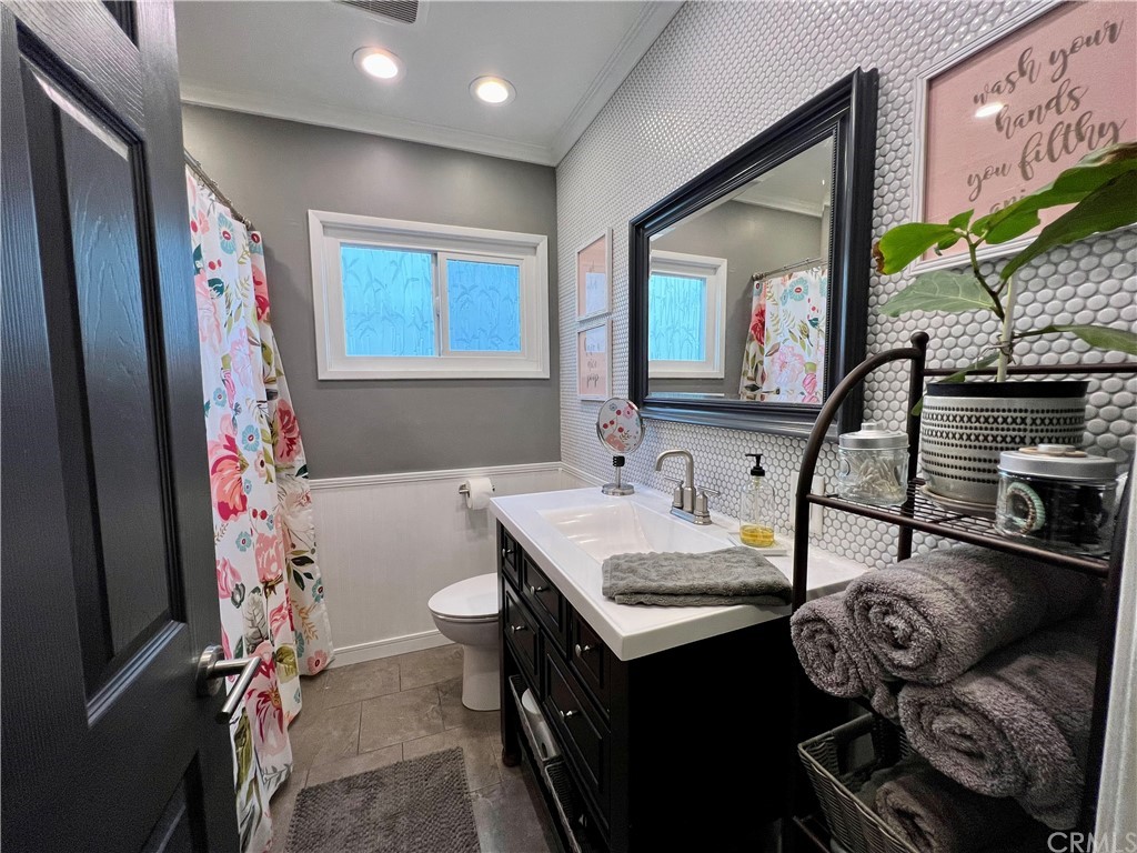 3713 North Studebaker Road Long Beach, CA 90808 - Photo 13 of 15 a bathroom with a sink mirror vanity and toilet