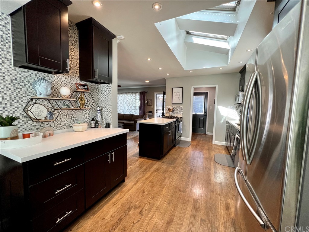 3713 North Studebaker Road Long Beach, CA 90808 - Photo 6 of 15 a kitchen with stainless steel appliances granite countertop a sink stove and refrigerator
