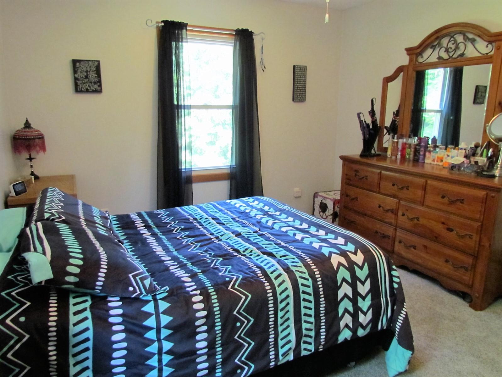 81 Jamison Mill Road Henry, VA 24102 - Photo 14 of 28 a bedroom with a bed and a mirror on dresser