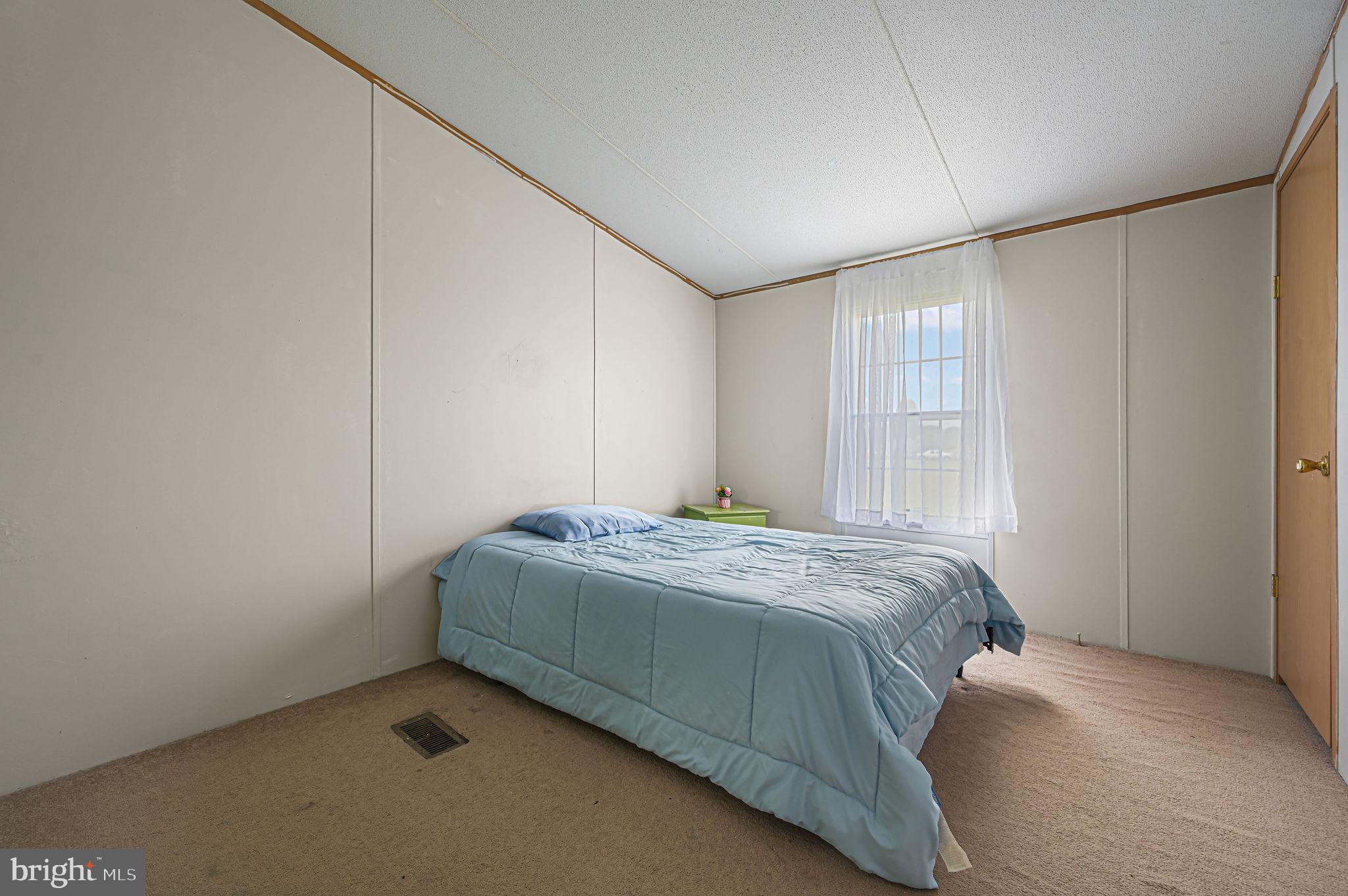 158 Caveat Road, Unit 200 Magnolia, DE 19962 - Photo 13 of 17 a bedroom with a bed and a window