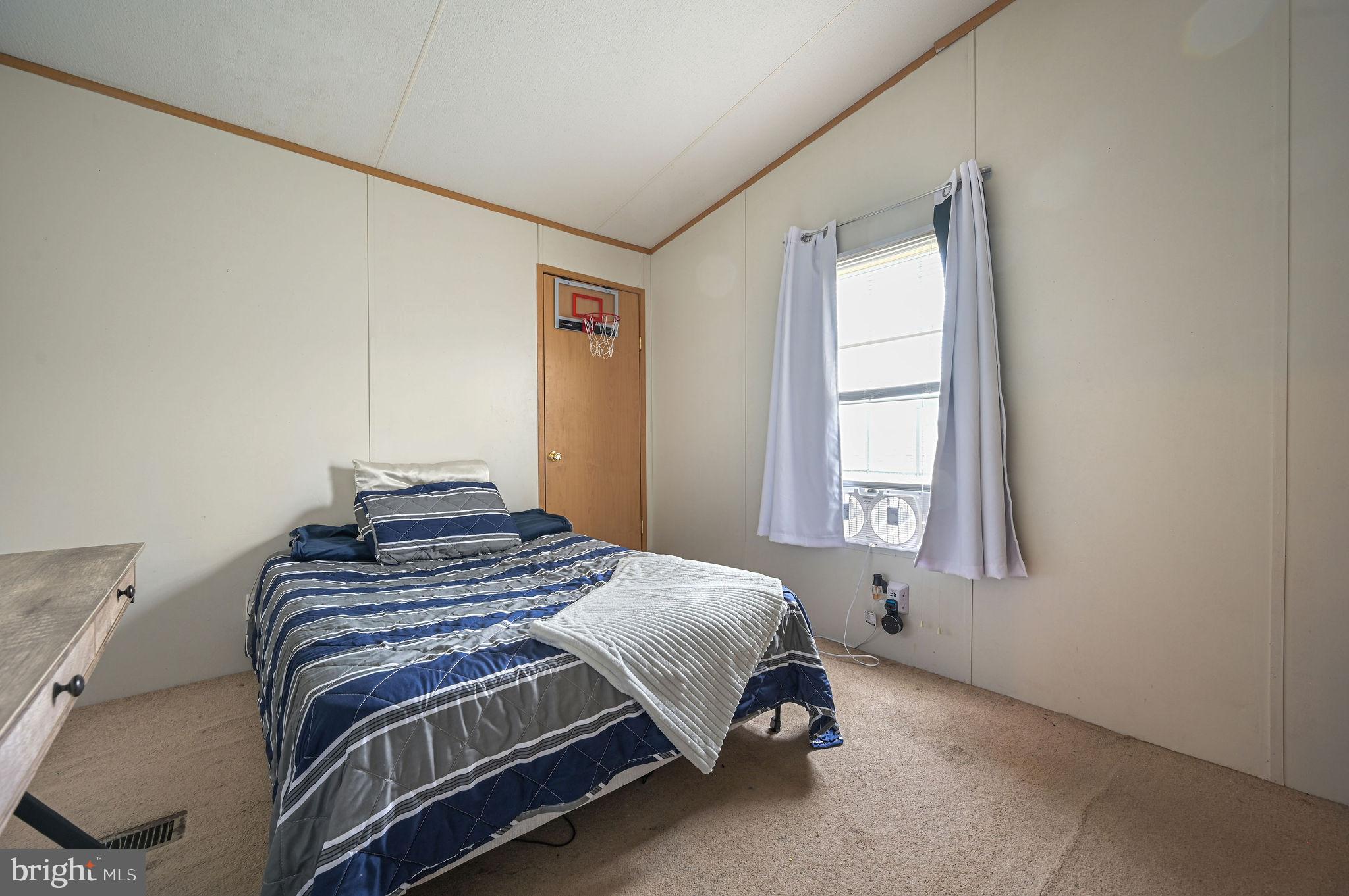 158 Caveat Road, Unit 200 Magnolia, DE 19962 - Photo 14 of 17 a bedroom with a bed and a window