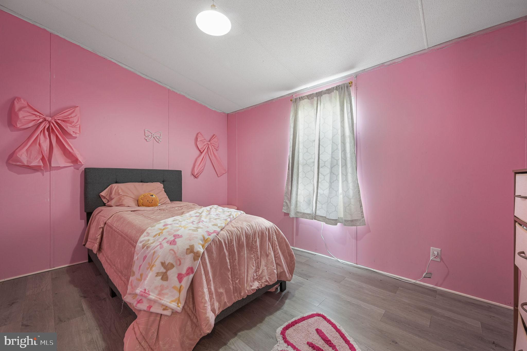 158 Caveat Road, Unit 200 Magnolia, DE 19962 - Photo 15 of 17 a bed room with a bed and a window