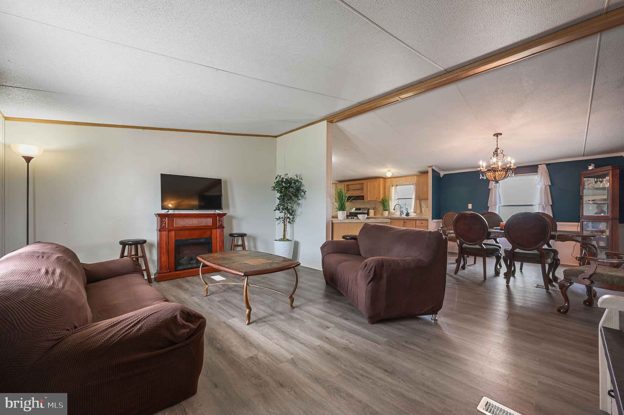 158 Caveat Road, Unit 200 Magnolia, DE 19962 - Photo 2 of 17 a living room with furniture and wooden floor