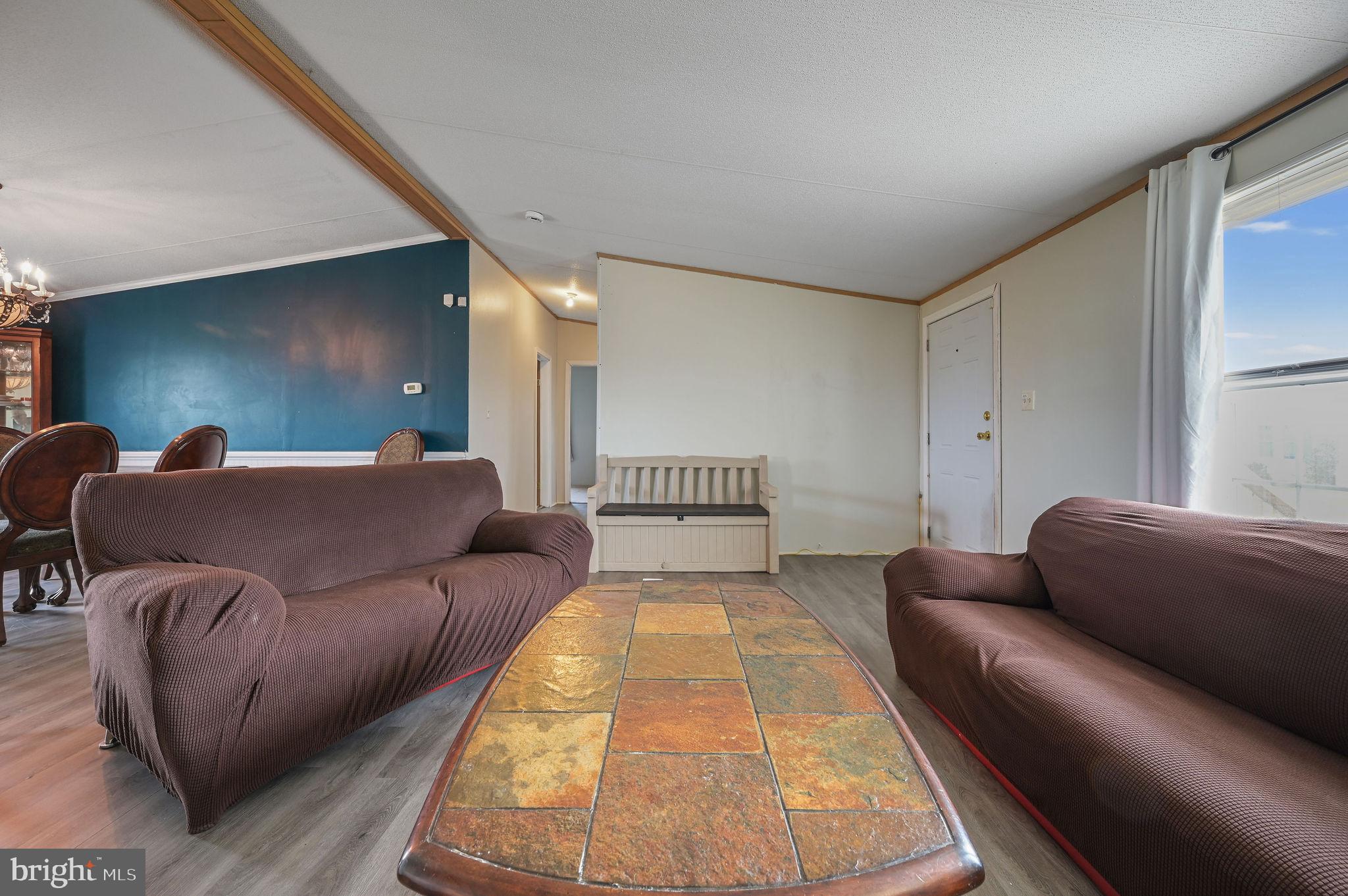 158 Caveat Road, Unit 200 Magnolia, DE 19962 - Photo 3 of 17 a living room with a couch and a coffee table