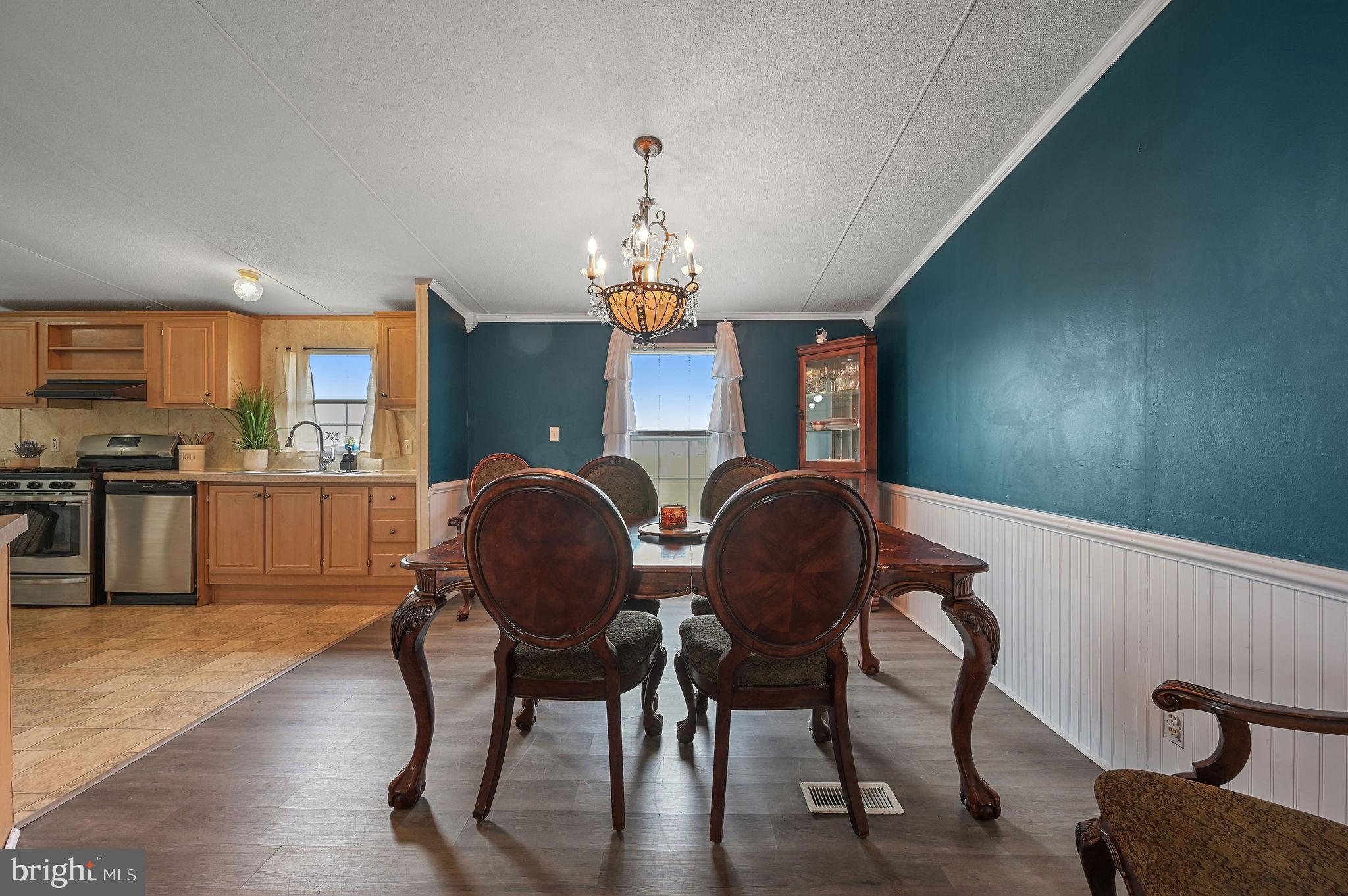158 Caveat Road, Unit 200 Magnolia, DE 19962 - Photo 4 of 17 a view of a dining room with furniture window and wooden floor