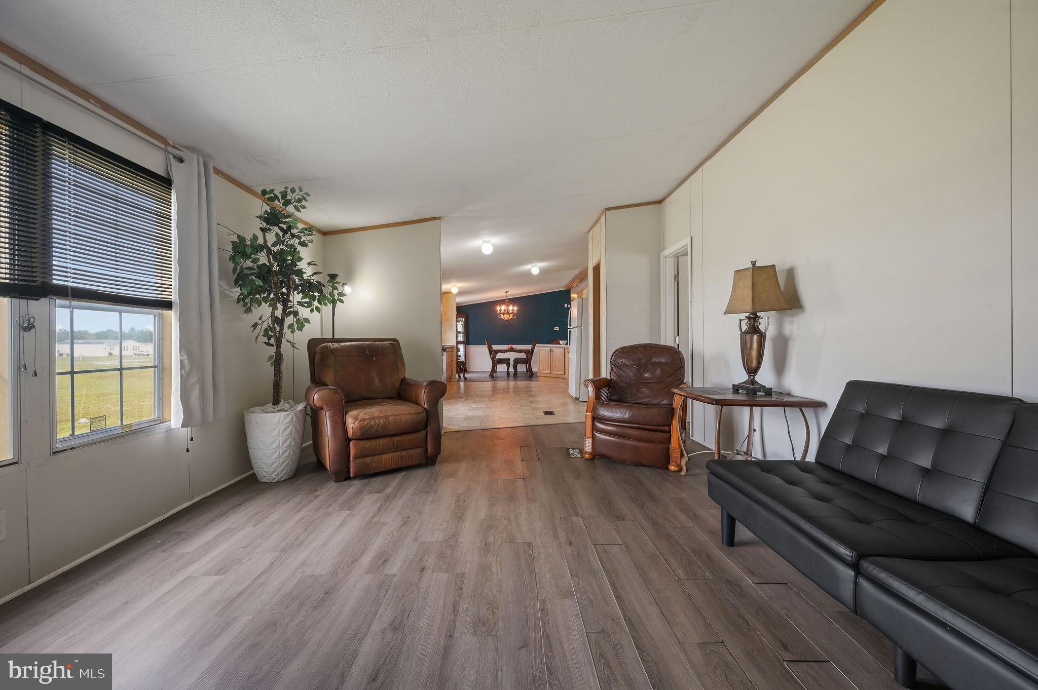 158 Caveat Road, Unit 200 Magnolia, DE 19962 - Photo 8 of 17 a living room with furniture and a wooden floor