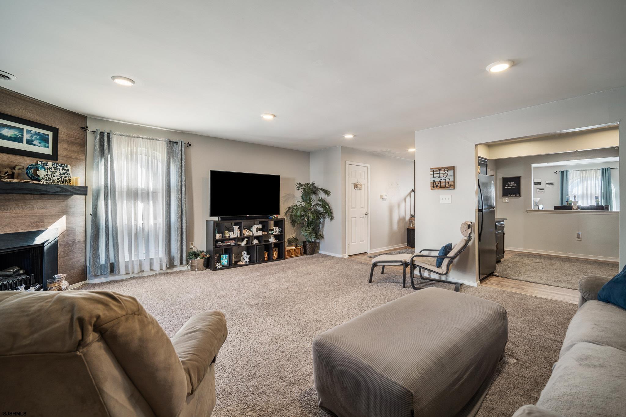 72 Delmar Drive Brigantine, NJ 08203 - Photo 11 of 29 a living room with furniture and a flat screen tv