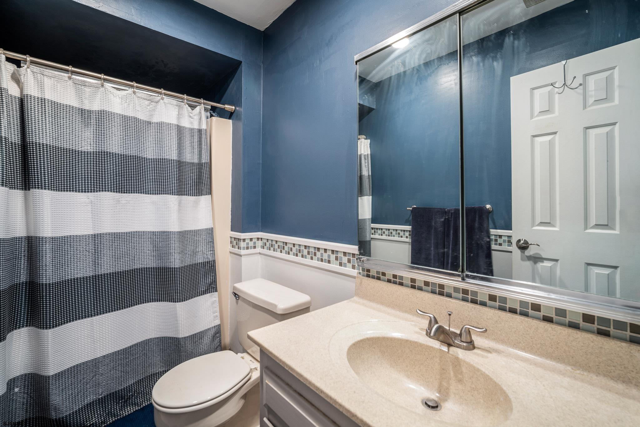72 Delmar Drive Brigantine, NJ 08203 - Photo 19 of 29 a bathroom with a sink and toilet