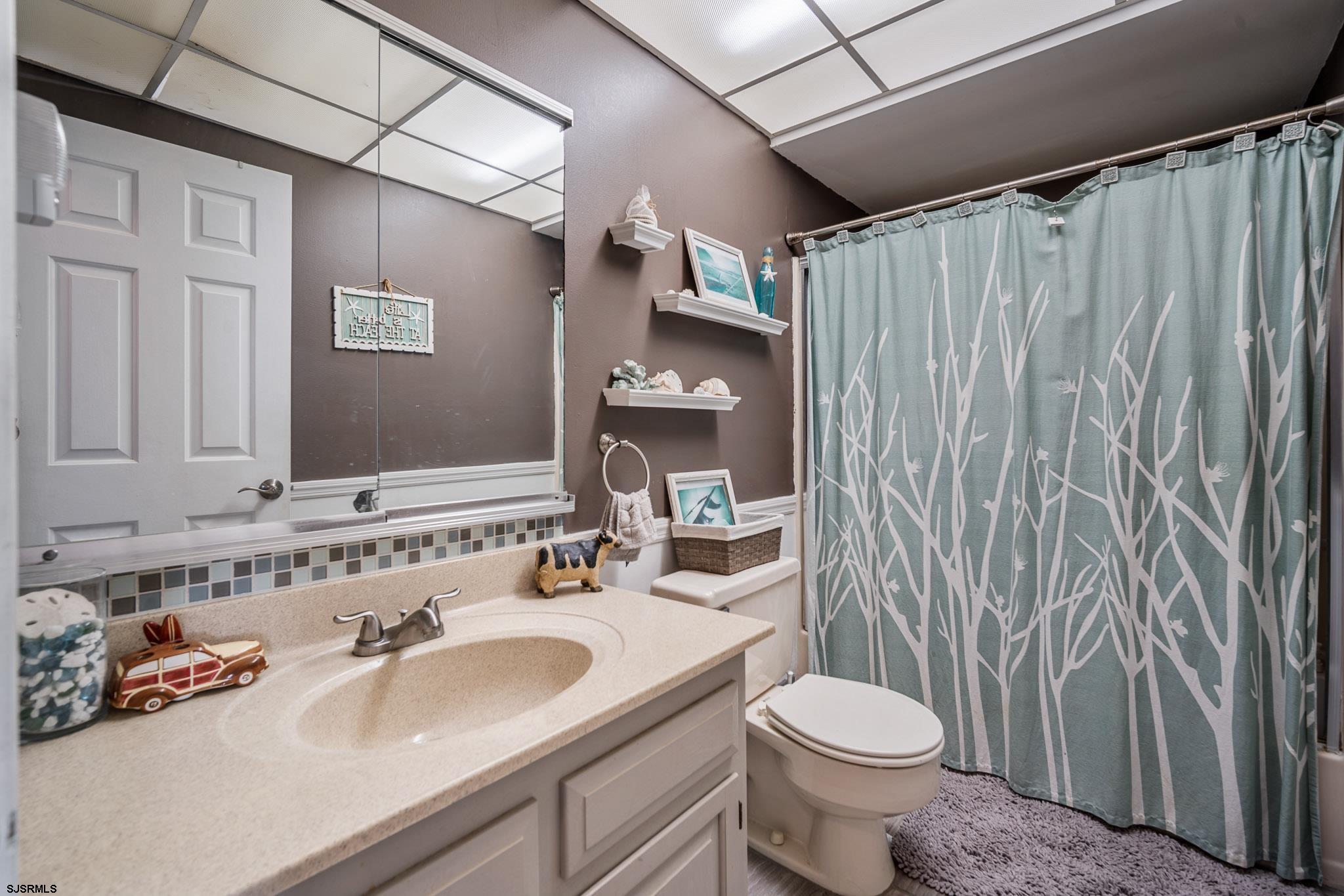 72 Delmar Drive Brigantine, NJ 08203 - Photo 22 of 29 a bathroom with a sink toilet and shower