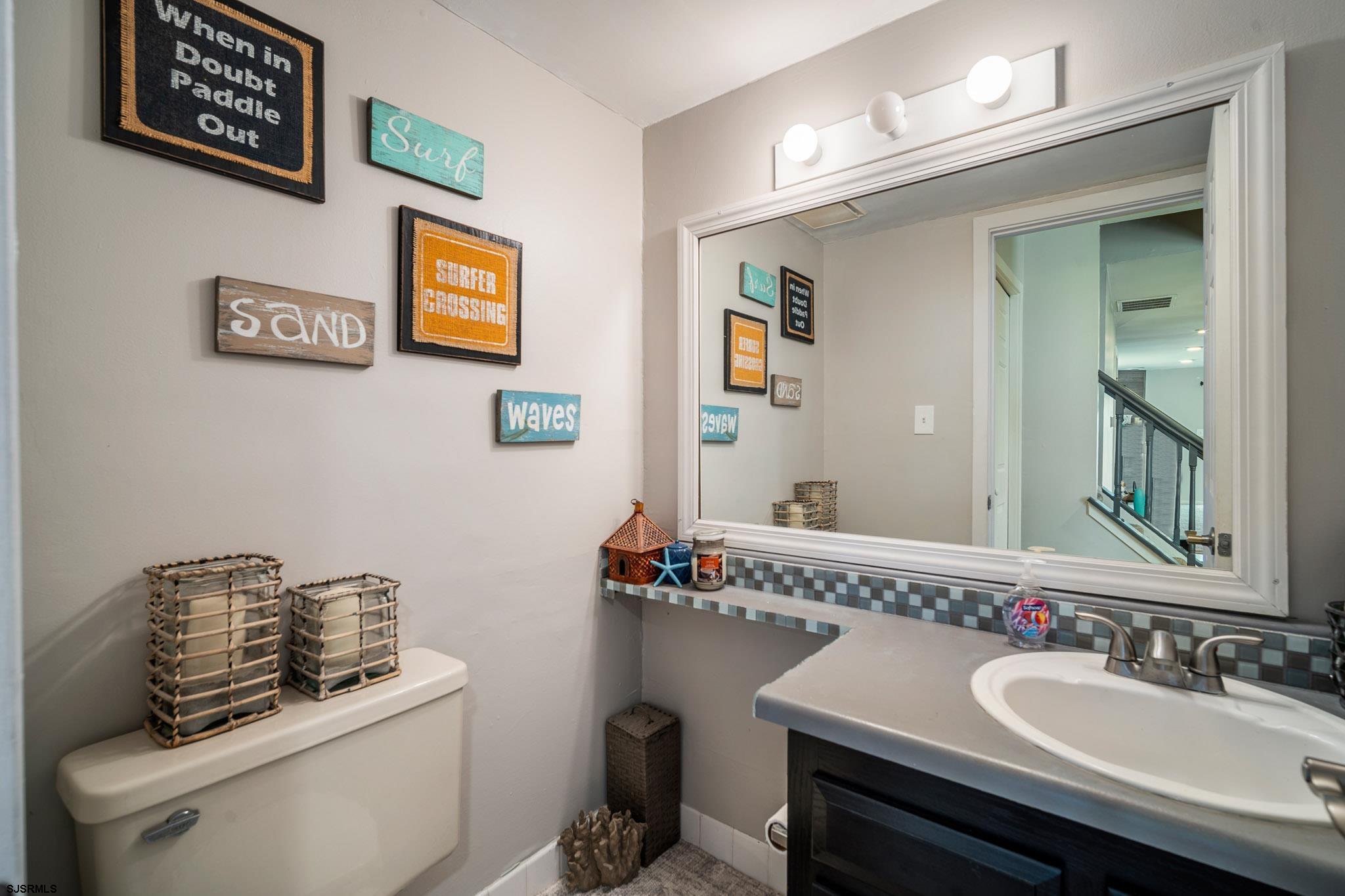 72 Delmar Drive Brigantine, NJ 08203 - Photo 7 of 29 a bathroom with a sink and a mirror