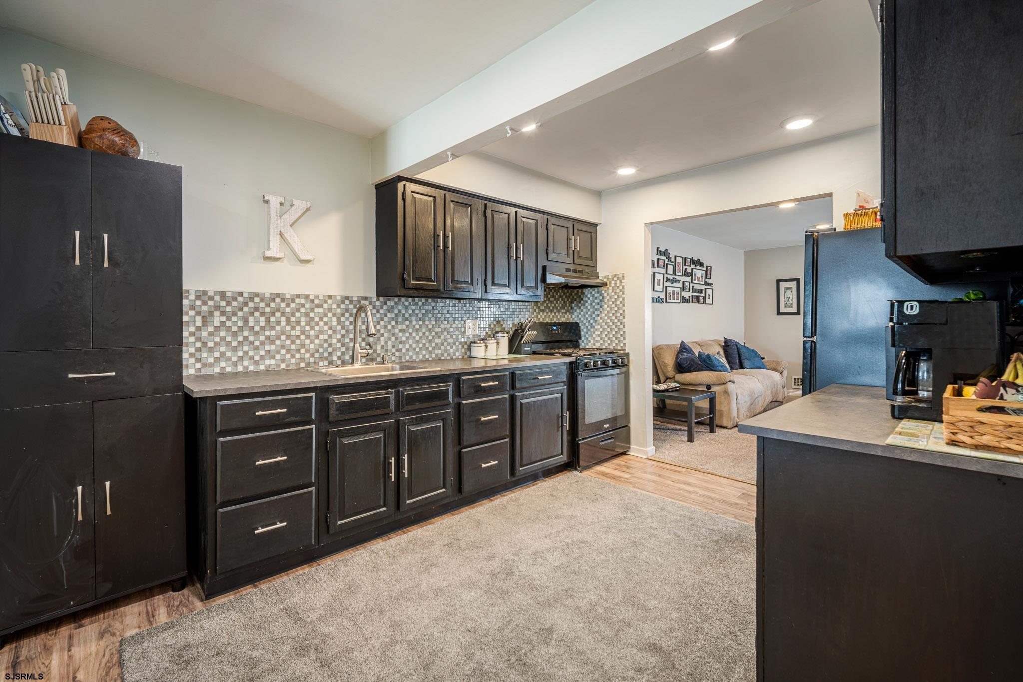 72 Delmar Drive Brigantine, NJ 08203 - Photo 9 of 29 a kitchen with stainless steel appliances granite countertop a sink stove and cabinets
